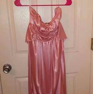 A pink strapless dress with gold accent in it